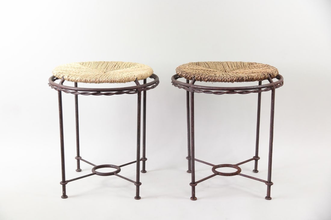 Pair of Wrought Iron Stools, Woven Seagrass Seats: Pair of Wrought Iron Stools, Woven Seagrass Seats. Stools with wrought iron frames featuring twisted details and round, woven seagrass seats. Dimensions are 17.5 in h x 15.5 in w x 15.5 in d.