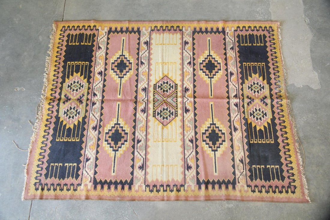 Turkish Style Geometric Wool Rug: Turkish Style Geometric Wool Rug. A wool rug with bold, geometric patterning in mustard, black, mauve, and sage green. Dimensions are 87.25 in l x 67.5 in w. Condition is fair, ends are unraveling. So