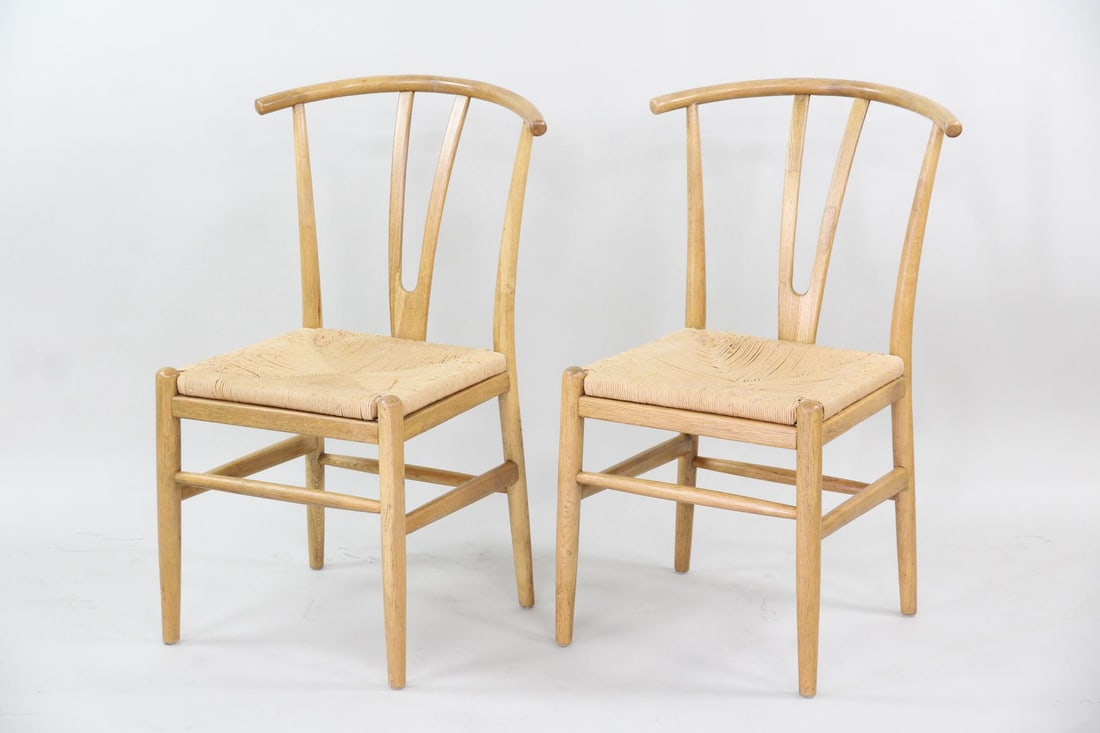 Pair of Wishbone Chairs, Wood with Rush Seats: Pair of Wishbone Chairs, Wood with Rush Seats. Pair of light wood chairs, likely oak, featuring wishbone-style frames and woven rush seats. Dimensions are 34.75 in h x 18 in w x 19 in d. Seat rise is 