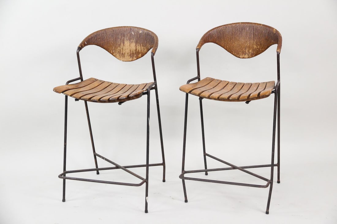 Pair of Arthur Umanoff Iron & Wicker Barstools: Pair of Mid-century Modern Arthur Umanoff Iron & Wicker Stools. Matching barstools with thin iron frames, slatted wood seats, and curved, wicker backs. Unmarked. Dimensions are 34.5 in h x 18.5 in w x