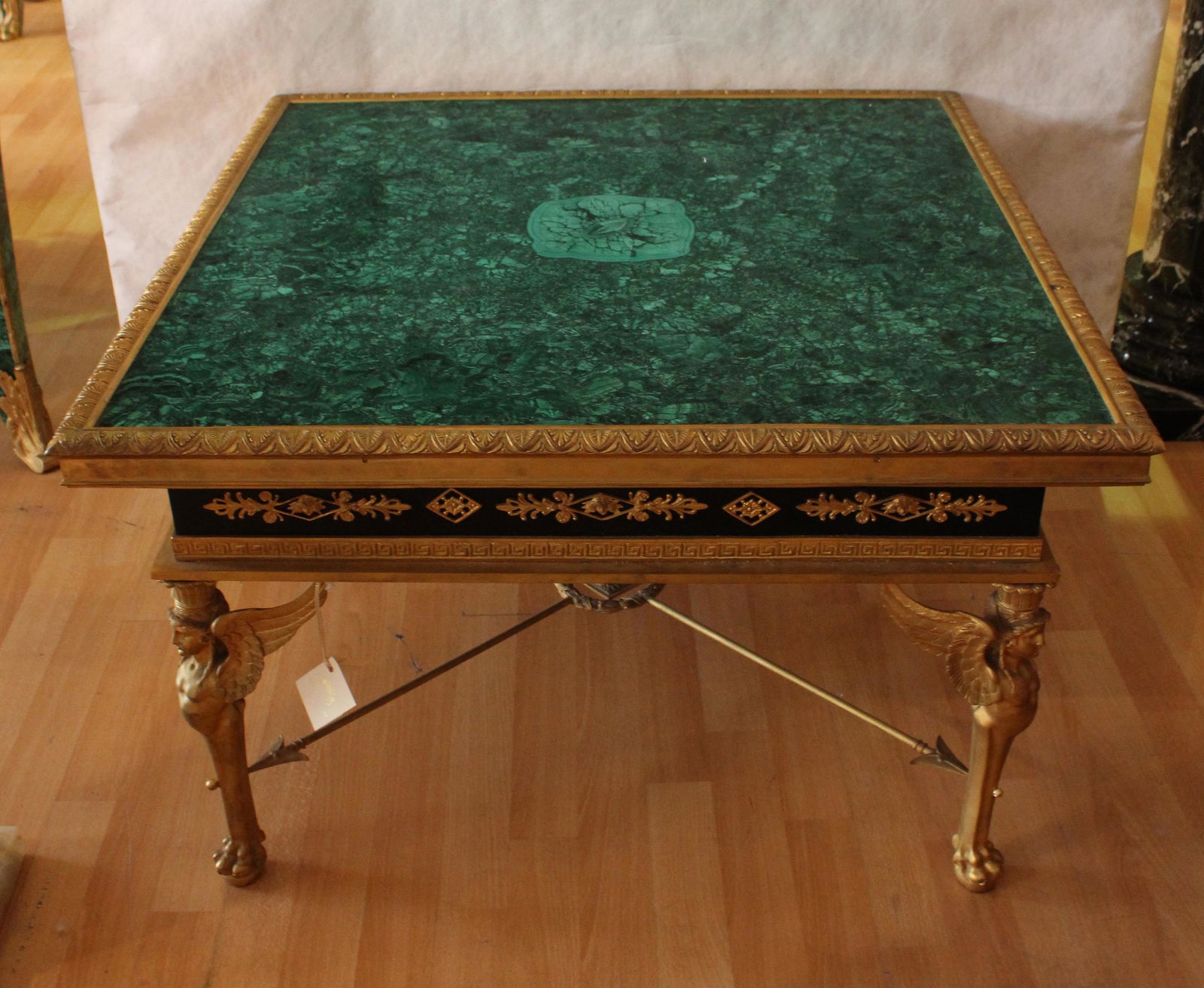 French Louis XIV Style Malachite and Dore Bronze Coffee: French Louis XIV Style Malachite and Dore Bronze Coffee Table. Malachite mounted with Gilt Bronze Figural Legs of Griffins ending in lion paws. From Hillsborough Estate Approximately 20 x 31 x 31 inch