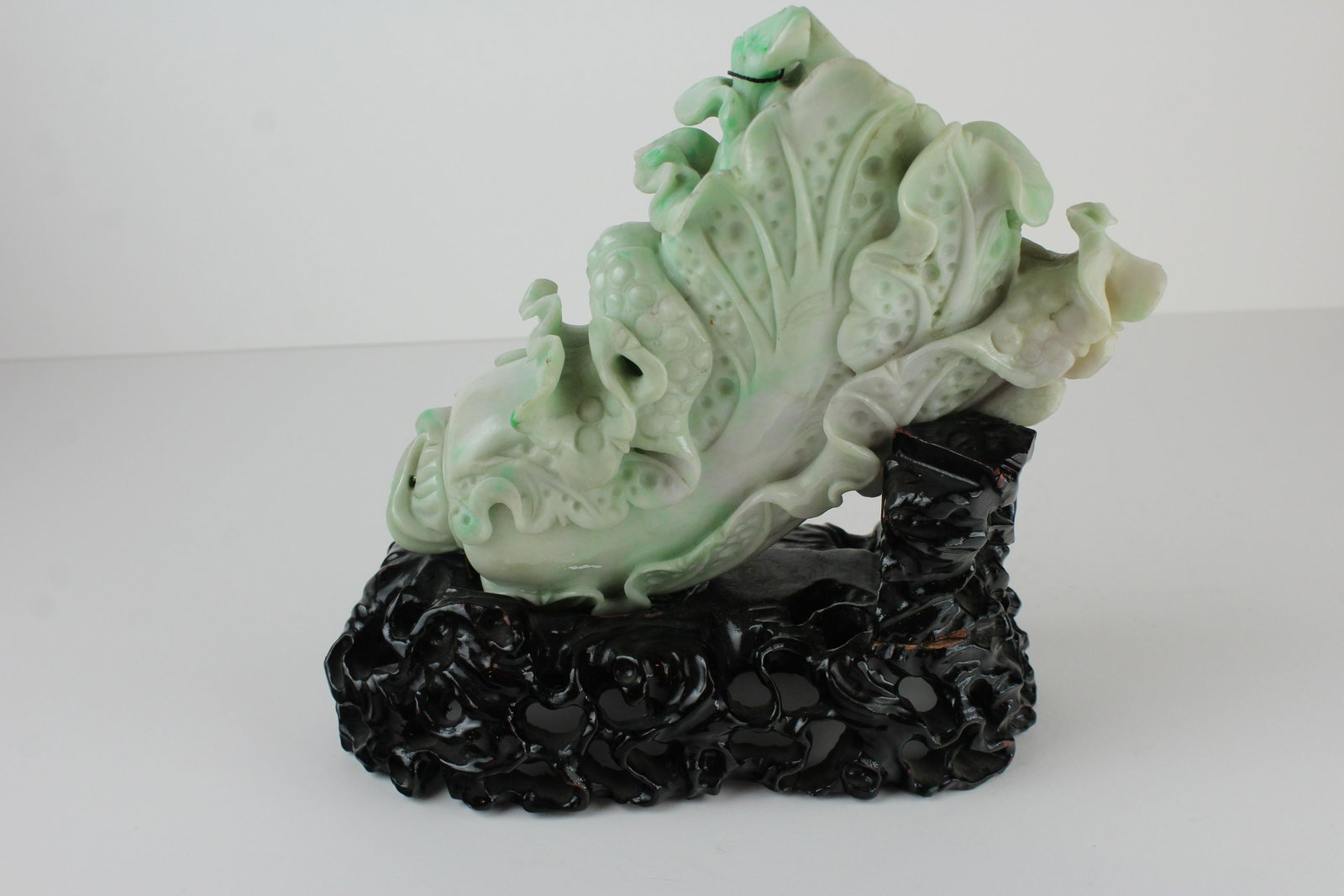 Chinese Multicolor Jade Bok Choy Carving.: Chinese Multicolor Jade Bok Choy Carving. Depicting an innately carved Bok Choy of moist, white and palge green appearence. On lacuqered wood base. From Private Collector Approximately 9 x 8.5 x 3.75 
