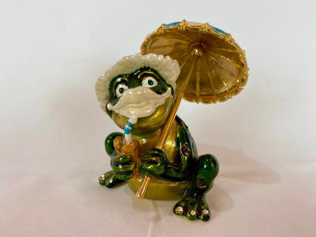 Keren Kopal Faberge Style Frog with an Umbrella Enamel: Keren Kopal Faberge Style Frog with an Umbrella. Plated with 24K gold and with strategically placed crystals. The trinket box has a magnetic fastener to secure the closure. From Local Estate approx 4x