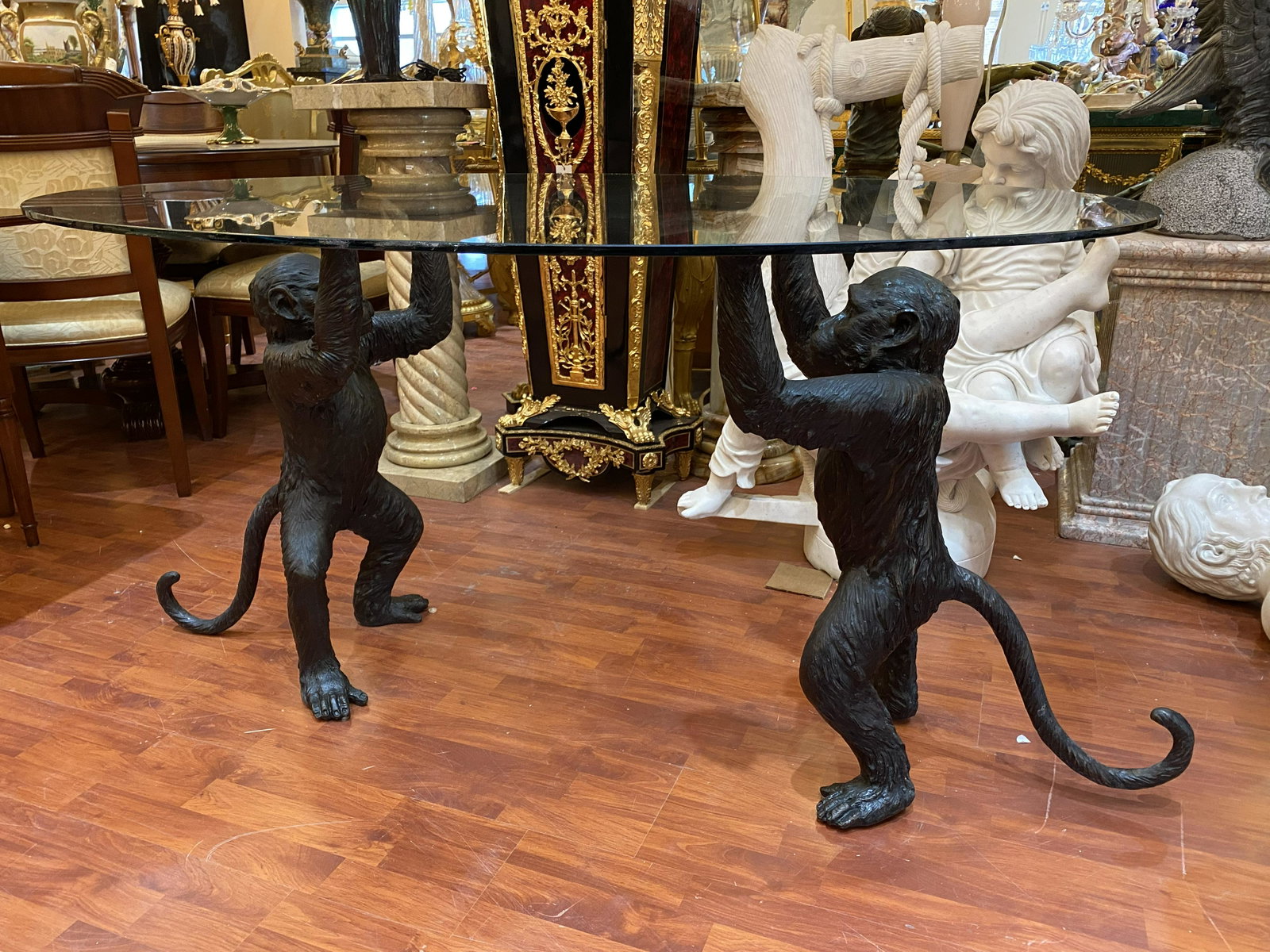Bronze Chimpanzee Center Table with Oval Glass Top: Bronze Chimpanzee Center Table with Oval Glass Top. Two cheeky chimps are holding up the oval glass top. Approx 30" x 58" x 38" inches