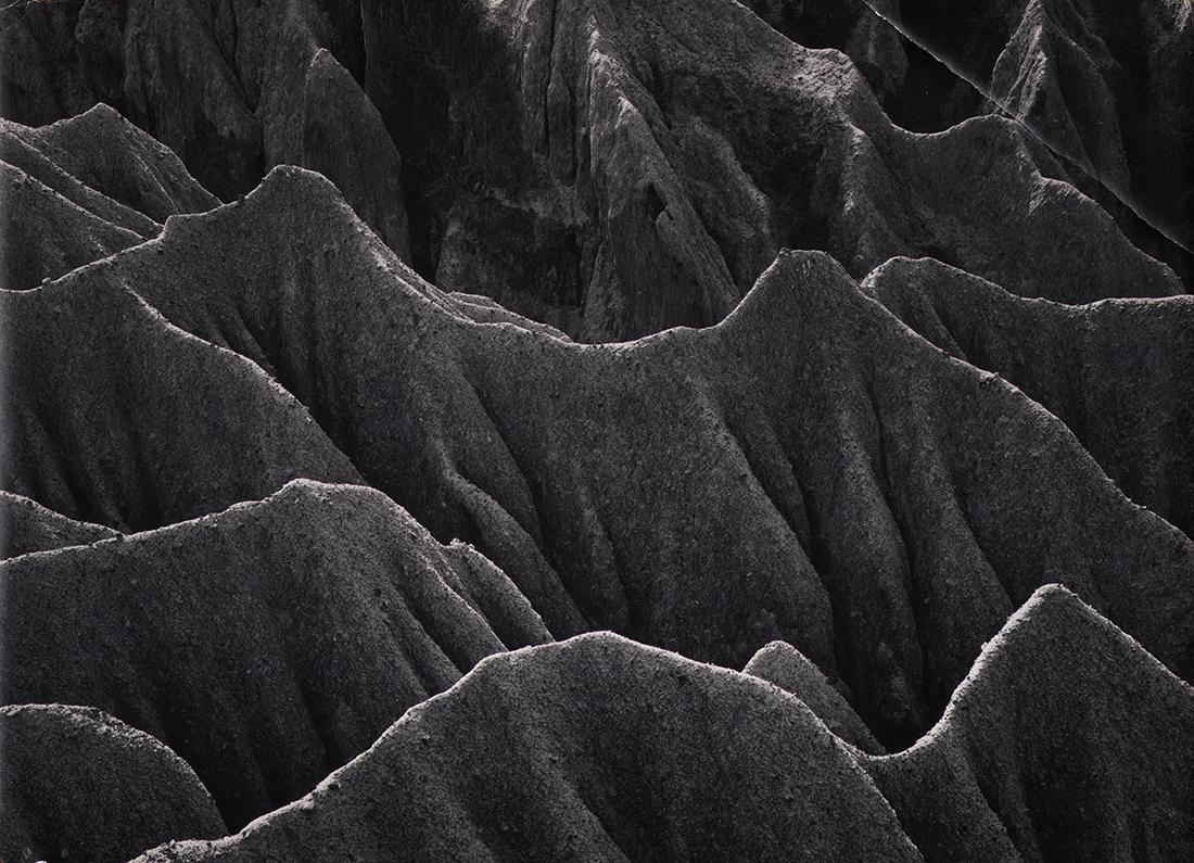 CALIFORNIA MID-CENTURY: Don Worth: Don Worth, Erosion, Laguna Beach, California, c. 1957, Vintage gelatin silver print, 9.5" x 13.25". Artist's credit stamped on verso. Titled in pen on verso. Crop marks and notations in pencil on vers