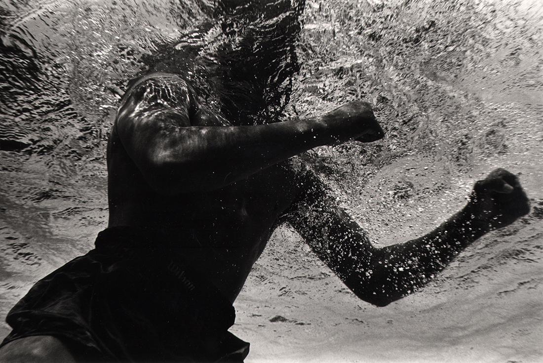 Flip Schulke, Ali Boxing Underwater, 1961: Flip Schulke, Ali Boxing Underwater, 1961, Gelatin silver print, 11" x 14". Artist's credit affixed to verso. Numbered in pencil on verso. Artist Biography: Flip Schulke, a native of New Ulm, Minnesot