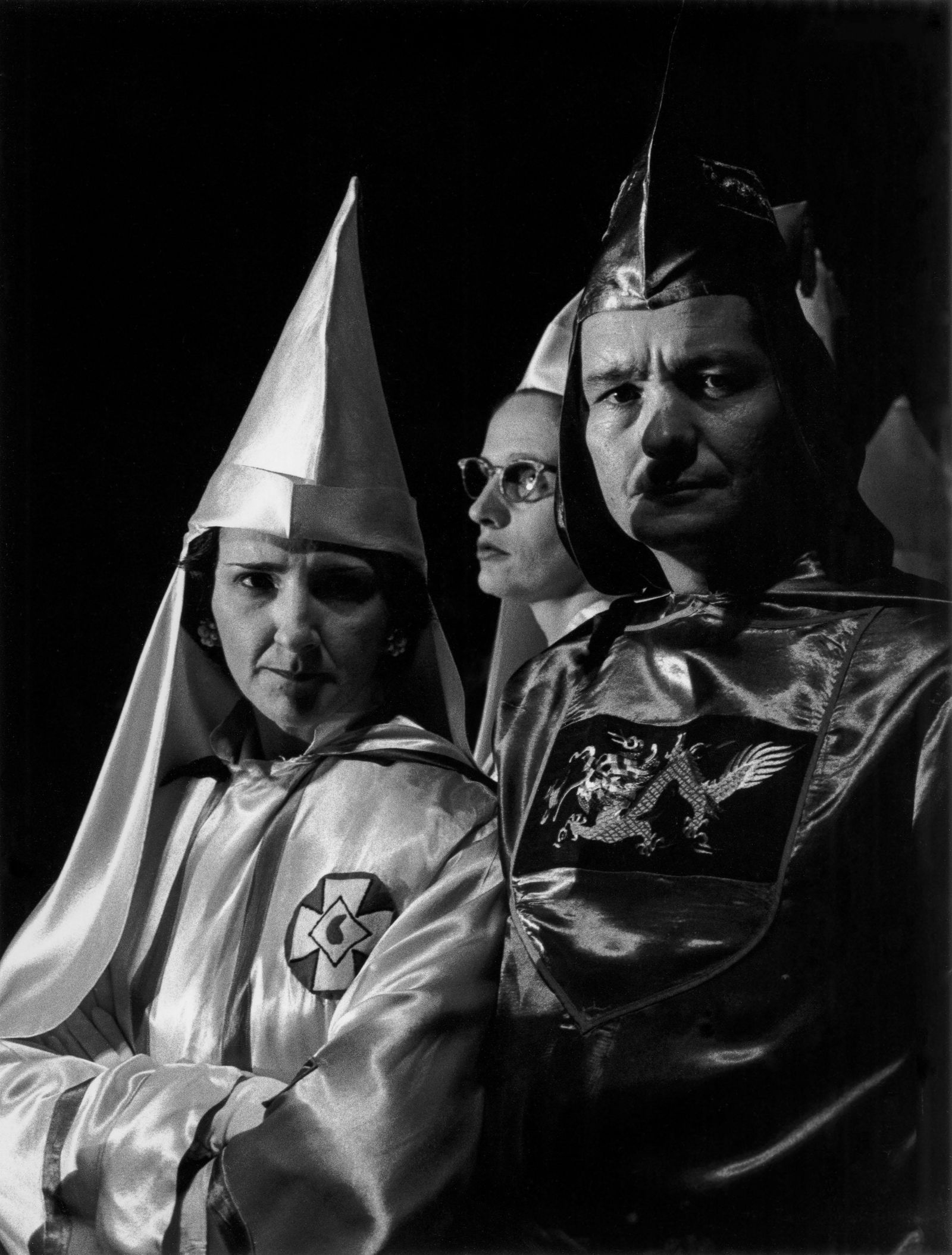 CHARLES MOORE Grand Dragon Jones attends a Klan rally,: Charles Moore (1931-2010) GRAND DRAGON JONES ATTENDS A KLAN RALLY. A CONFEDERATE FLAG IS EMBROIDERED ON HIS SLEEVE. THE CROSS ON THE WOMAN’S ROBE REPRESENTS THE CRUCIFIXION; THE MARK IN THE CENTER,