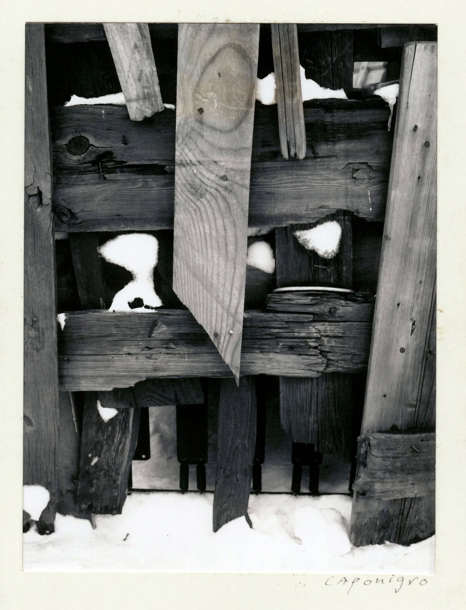 Section Of Old Wood Fence With Snow, 1965: PAUL CAPONIGRO (1932-), SECTION OF OLD WOOD FENCE WITH SNOW ON GROUND, 1965 vintage Polaroid print, 3 x 2 in. (paper); signed recto; Condition: Excellent. PC-0081 Born in Boston in 1932, Paul Caponigr