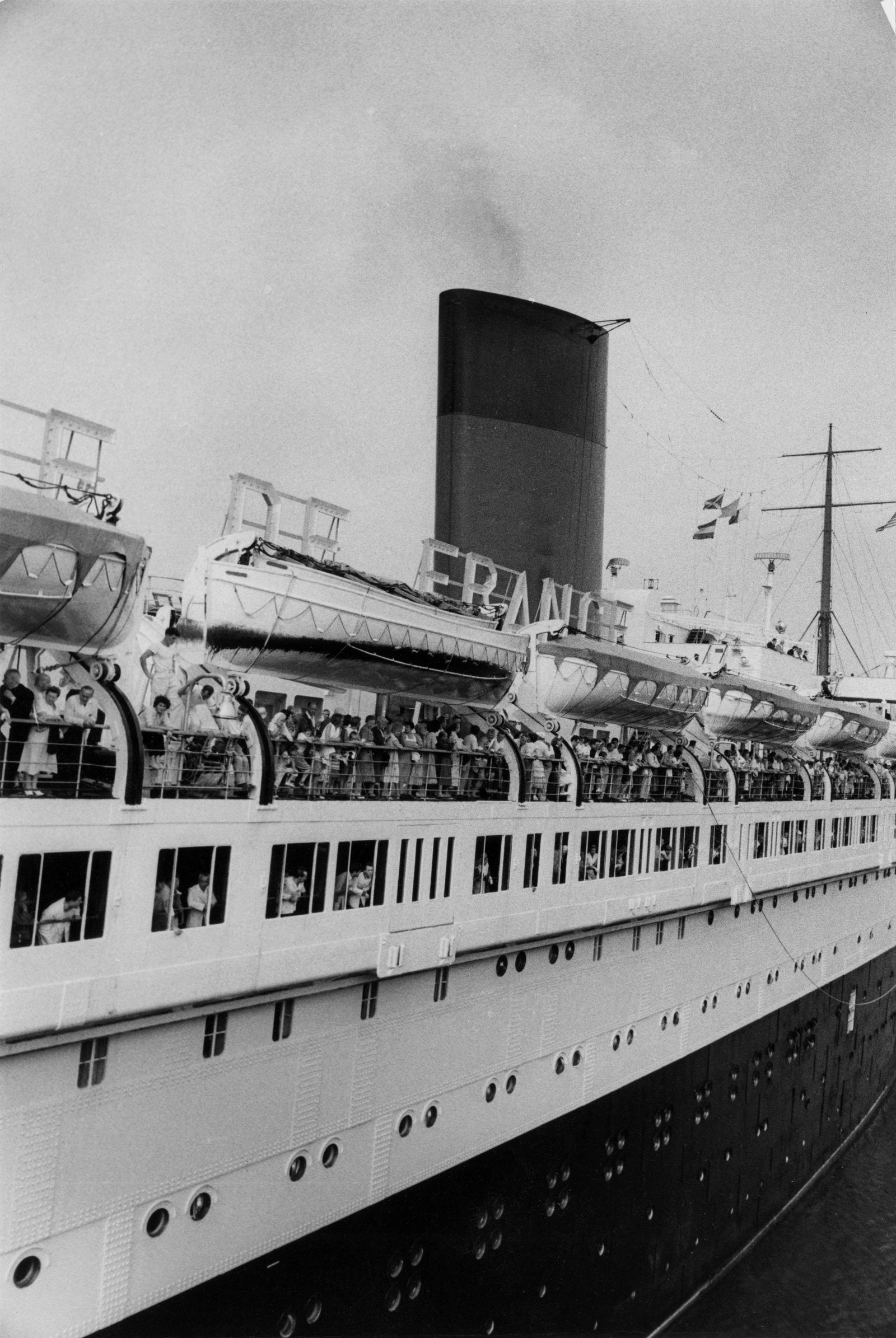 W. E. SMITH, SURVIVORS FROM THE ANDREA DORIA, 1956: W. EUGENE SMITH (1918-1978) SURVIVORS FROM THE ANDREA DORIA ABOARD FRENCH RESCUE SHIP, ILE DE FRANCE, 1956 vintage gelatin silver print; 6 3/4 x 9 3/4 in. (image); Magnum Photo stamp with handwritten