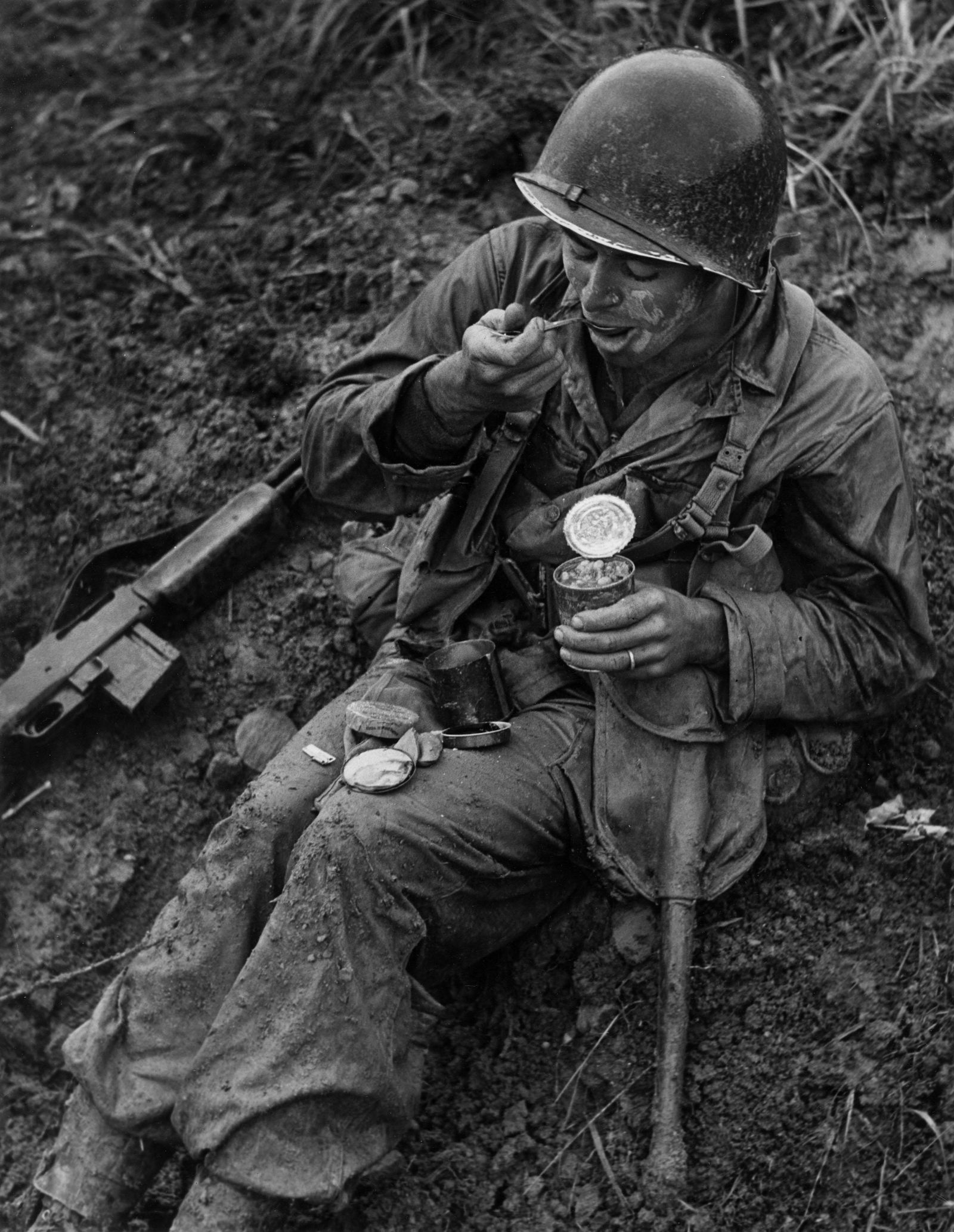 W. E. SMITH, G-I TERRY MOORE, C-RATIONS, MAY 22, 1945: W. EUGENE SMITH (1918-1978) G-I, TERRY MOORE WITH C-RATION LUNCH, MAY 22, 1945 gelatin silver print, printer later, 13 5/8 x 10 5/8 in. (image), 14 x 11 (approx. sheet); W. Eugene Smith reproduction s