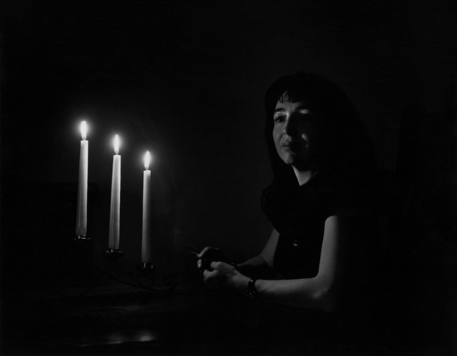 W. E. SMITH, NEW MEXICO, WOMAN WITH CANDLELIGHT, 1947: W. EUGENE SMITH (1918-1978), UNTITLED (NEW MEXICO, WOMAN WITH CANDLELIGHT), 1947 gelatin silver print, printed later; 10 1/2 x 13 3/8 in. (image); Photographer's 'Private Collection' stamp verso. Cond