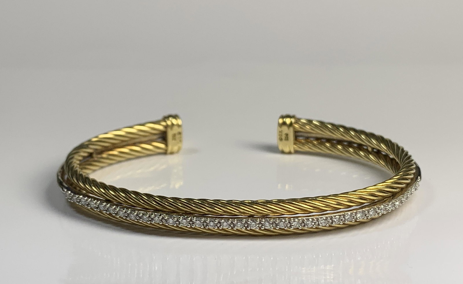 A David Yurman 18k Gold & Diamond Cable Cuff Bracelet: A Vintage David Yurman 18k Yellow Gold & Diamond Banded Three row Cable cuff Bracelet. Very rare and limited design. The Cuff Bracelet feat