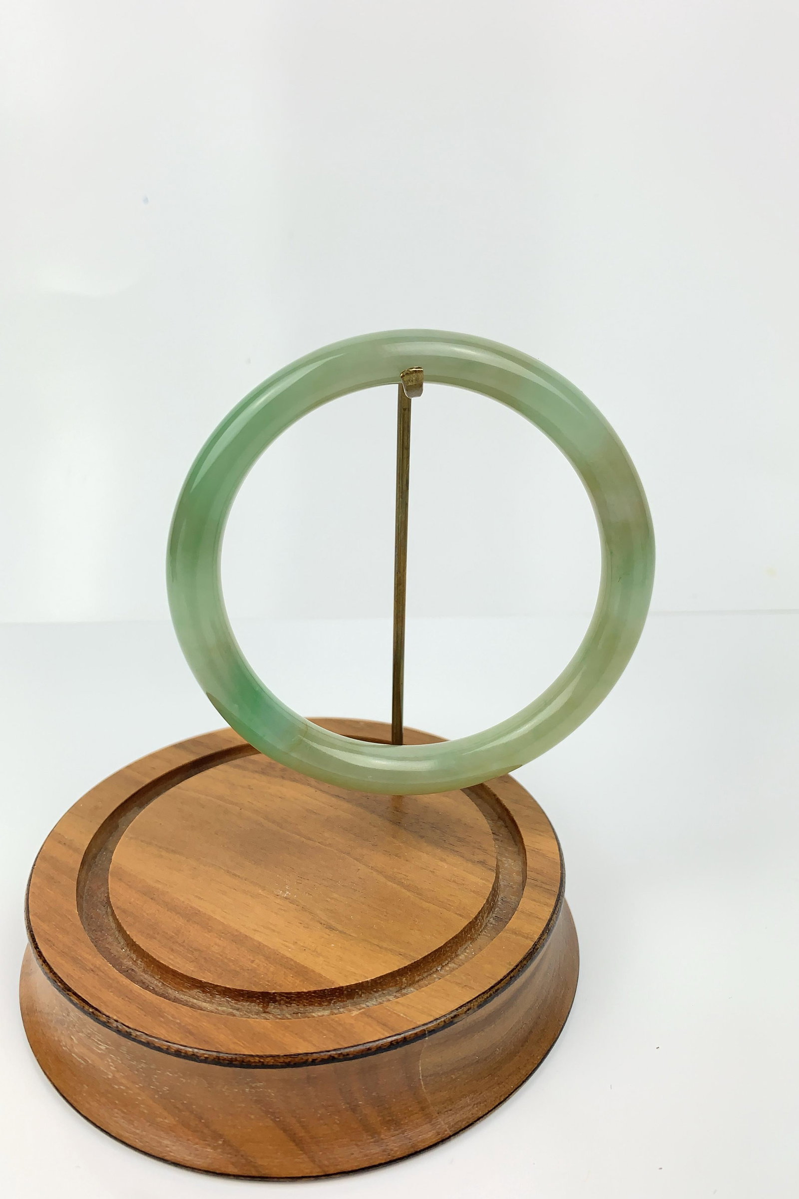 A Green Jadeite Bangle: Approximately: 80 mm (Diameter) x 54 mm (Inner Diameter) x 8.6 mm (Thickness) x 42.2 grams in weight