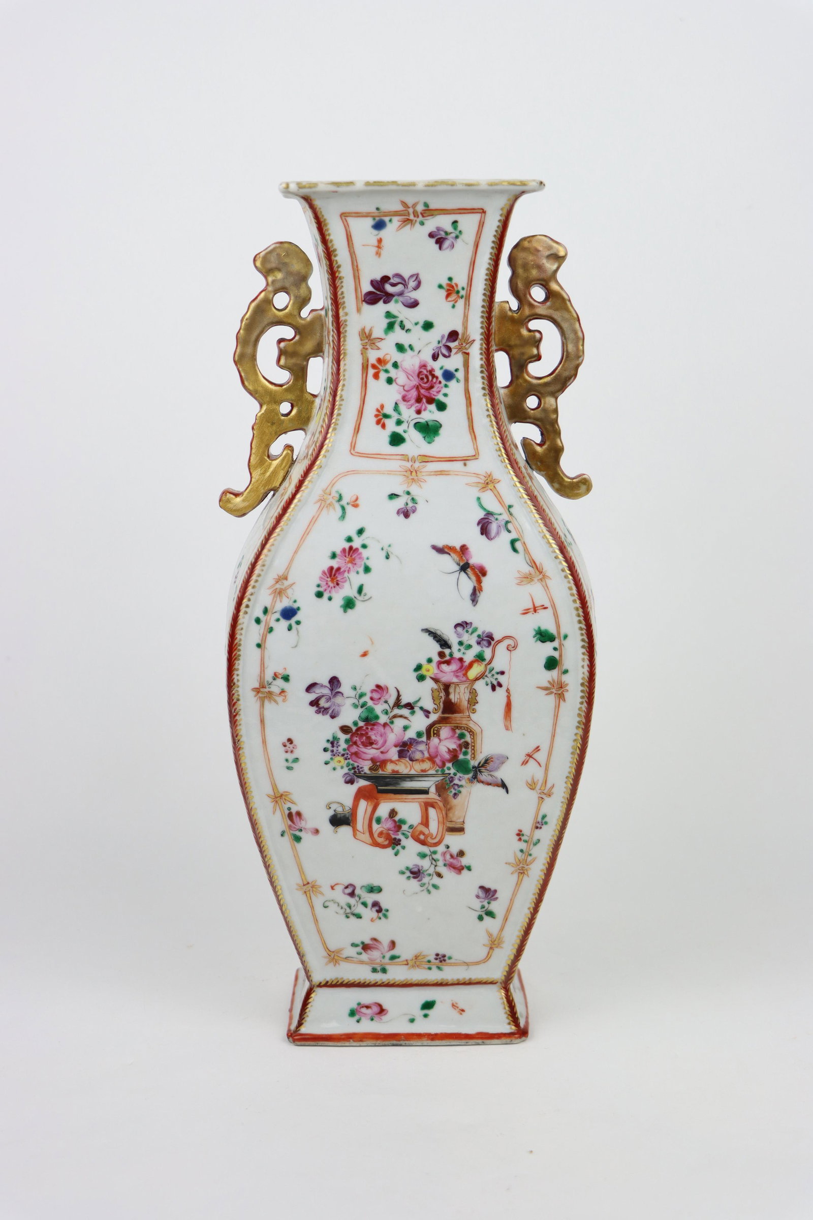 A Chinese Qianlong Famille Rose Enameled Square Vase: A Chinese Qianlong Famille Rose Enameled Square Vase featuring a pair of Gilt applied Dragon form handles. The vase of Squareish Ovoid Form with excellent and well preserved Enamel paintings of variou