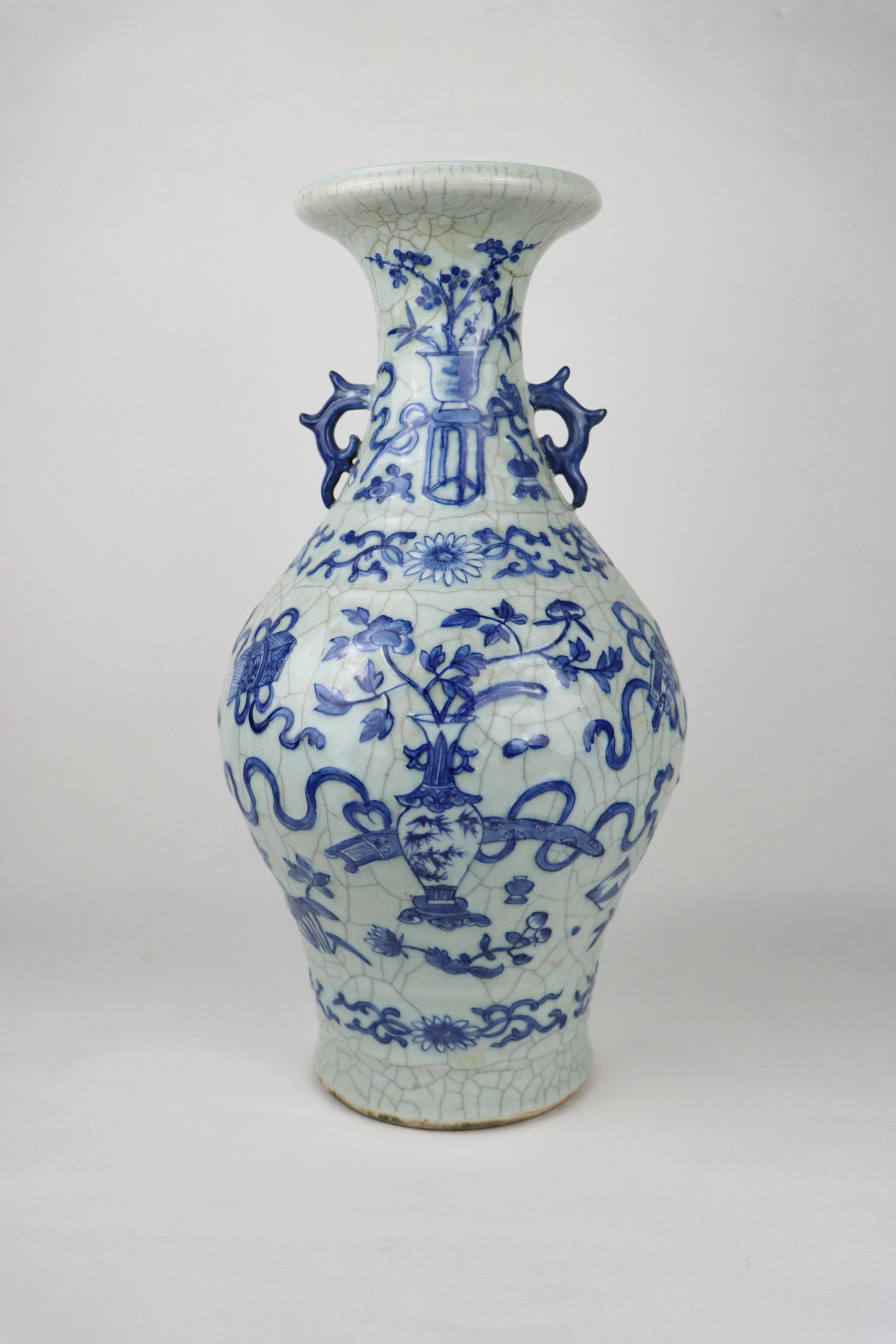 A Chinese Qing Blue & White Porcelain Vase: A Chinese Blue & White Porcelain Vase 19th Century, Qing Dynasty. The vase features a blue overglaze painting of Auspicious objects such as Vases with flowers, censers, ruyi staffs, bows, peonies, Ji 