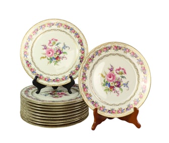A SET OF 12 ROSENTHALE IVORY VIENNA FLORAL PATTERN GILT TRIM PLATES