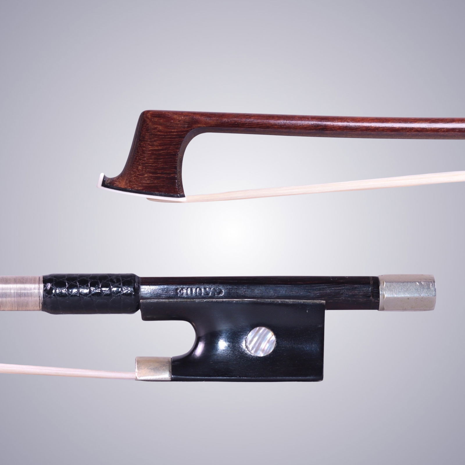 A VIOLIN BOW ATTRIBUTED TO JOSEPH GAUDE: A VIOLIN BOW ATTRIBUTED TO JOSEPH GAUDE Of Round Stick, Ebony & Silver mounted. Stamped on stick above frog: GAUDE Approximate Dimensions: 74.3 cm (Total Length - Head to Adjustor) 60.5 Grams in weigh