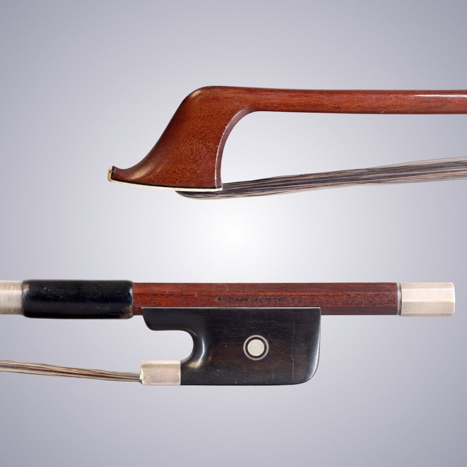 A SILVER MOUNTED BASS BOW STAMPED LOTHAR SEIFERT: A SILVER MOUNTED BASS BOW STAMPED LOTHAR SEIFERT Of Round Pernambuco Stick, Ebony & Silver mounted. Stamped on stick above frog: *LOTHAR SEIFERT* Approximate Dimensions: 68 cm (Total Length - Head to 