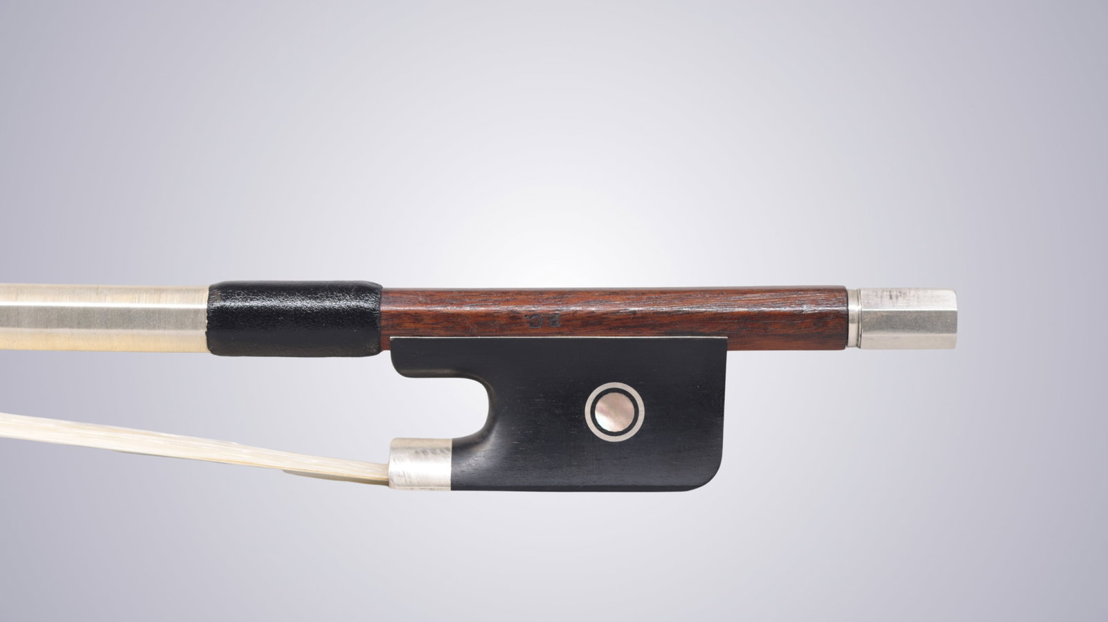 A SILVER MOUNTED CELLO BOW STAMPED P.C. - 2