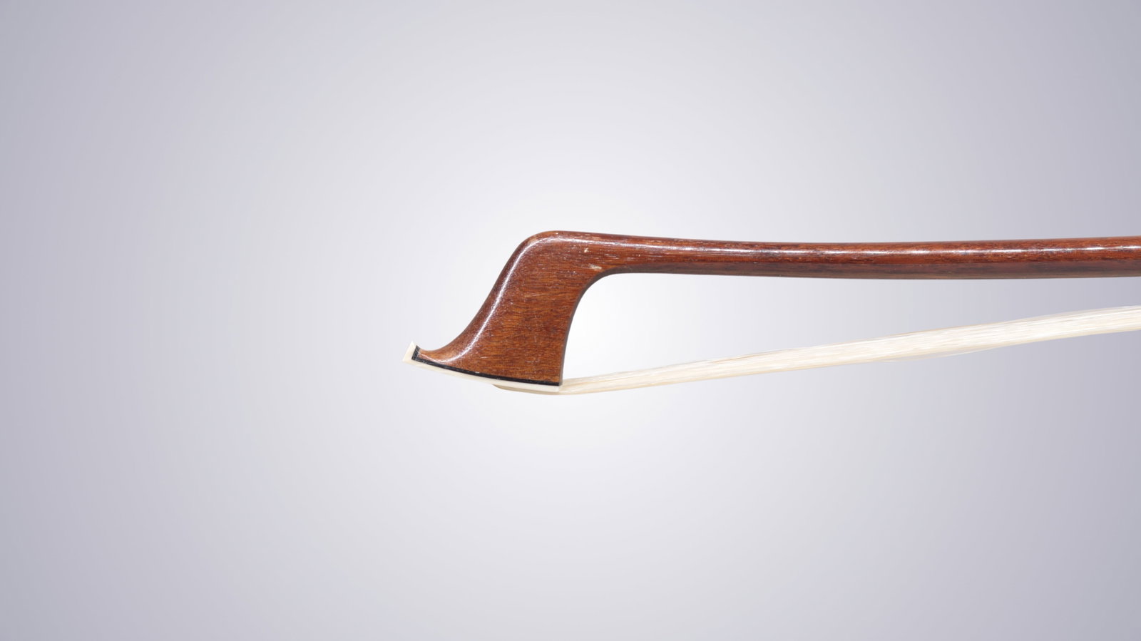 A SILVER MOUNTED CELLO BOW STAMPED P.C. - 3