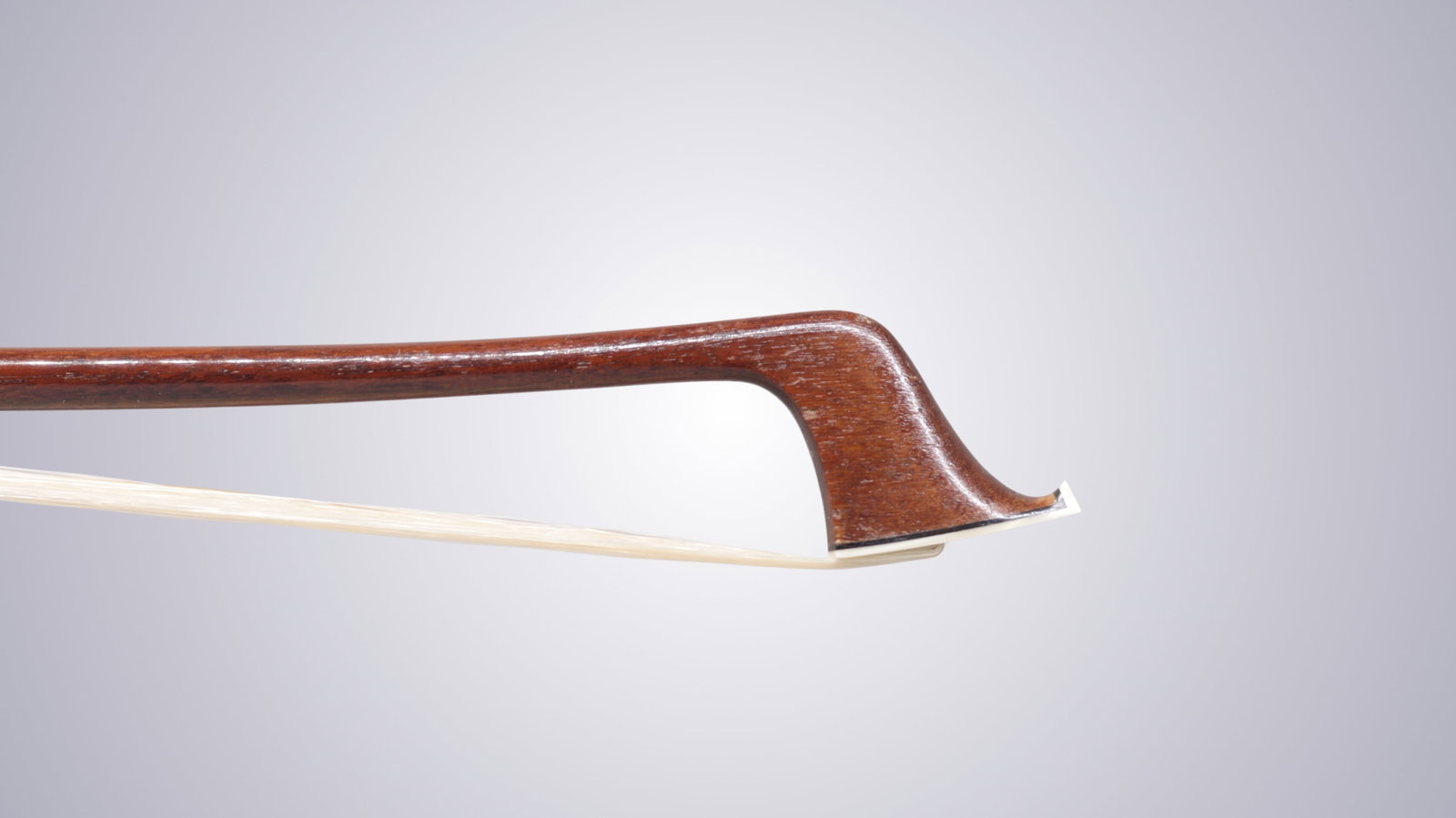 A SILVER MOUNTED CELLO BOW STAMPED P.C. - 5
