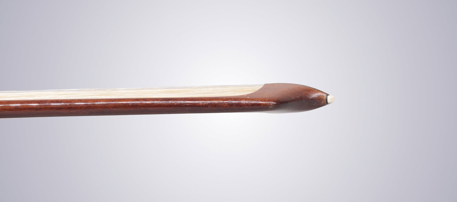 A SILVER MOUNTED CELLO BOW STAMPED P.C. - 6