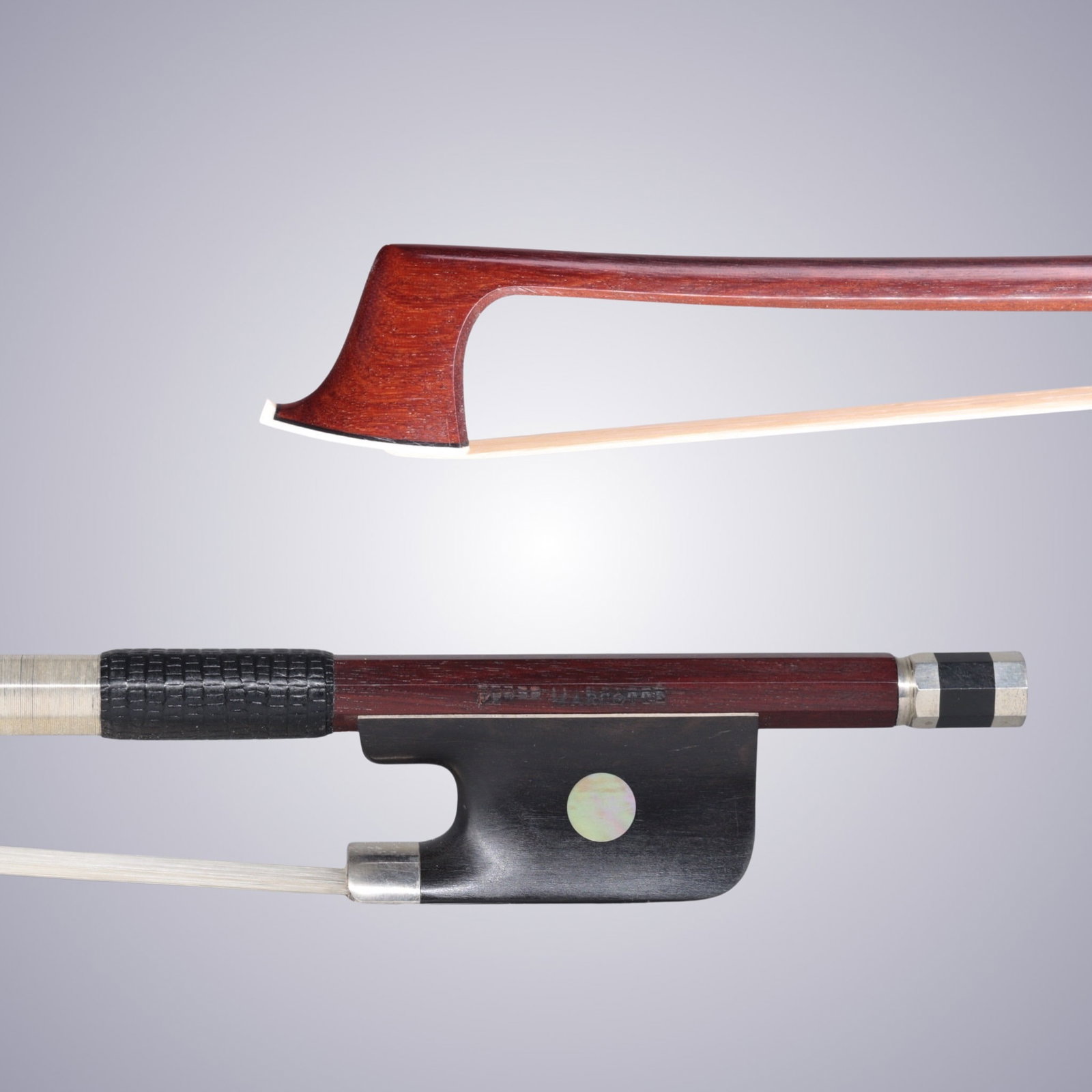 A VIOLA BOW STAMPED FERET-MARCOTTE: A VIOLA BOW STAMPED FERET-MARCOTTE Of Round Stick, Ebony & Silver mounted. Stamped on stick above frog: FERET-MARCOTTE Approximate Dimensions: 74.4 cm (Total Length - Head to Adjustor) 71.3 grams in