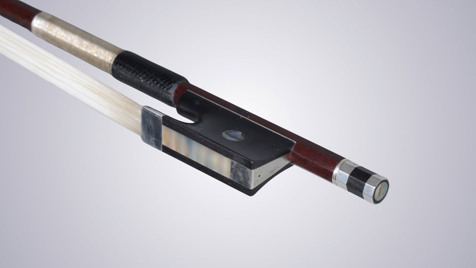 A VIOLIN BOW STAMPED P.C. - 11