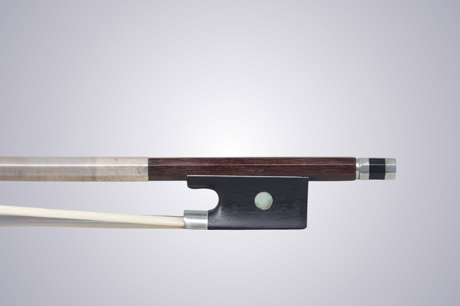 A VIOLIN BOW STAMPED P.C. - 12