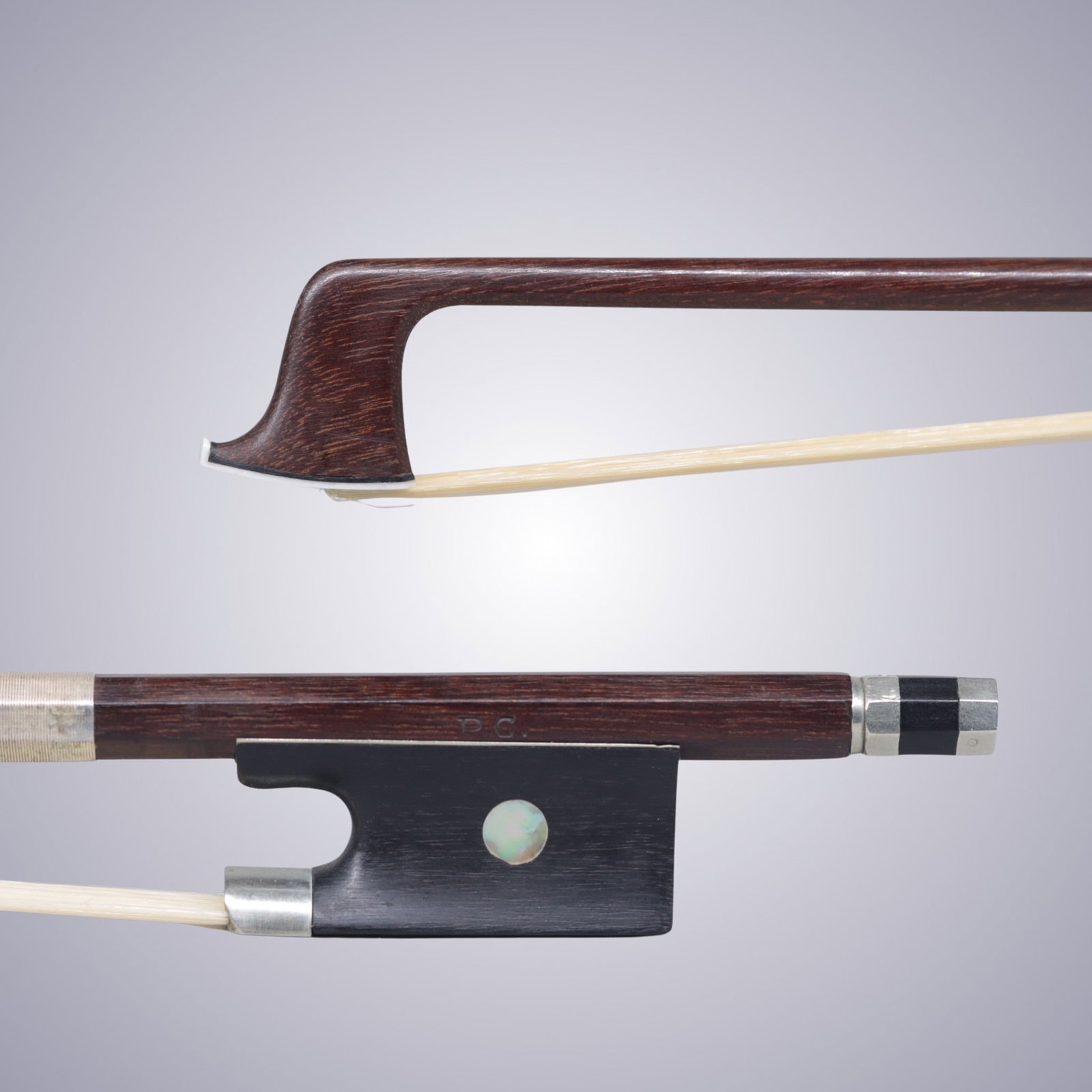 A VIOLIN BOW STAMPED P.C.: A VIOLIN BOW STAMPED P.C. Of Round Stick, Ebony & Nickel mounted. Stamped on stick above frog: P.C. Approximate Dimensions: 74.2 cm (Total Length - Head to Adjustor) 63.8 grams in weight