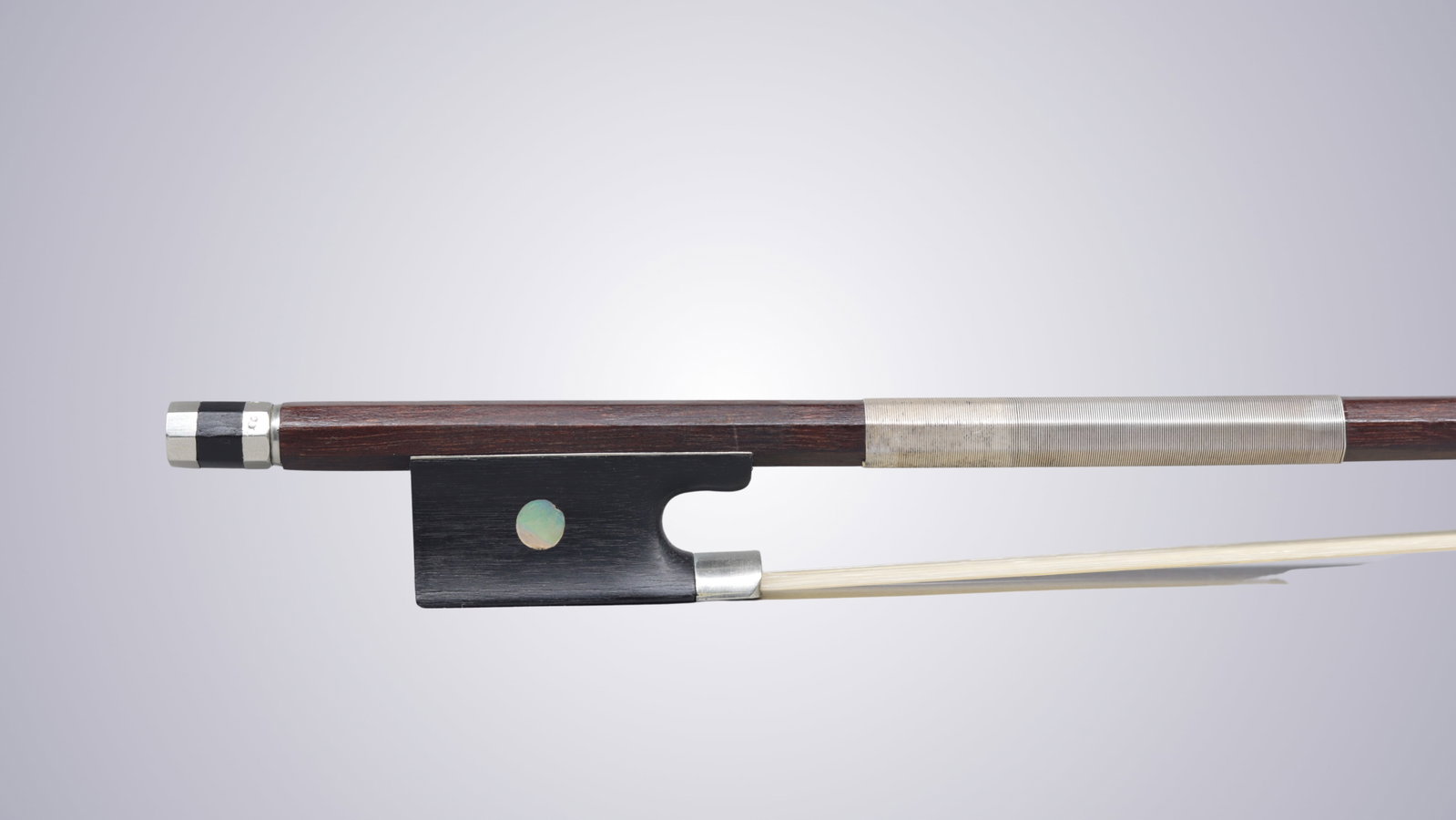 A VIOLIN BOW STAMPED P.C. - 9