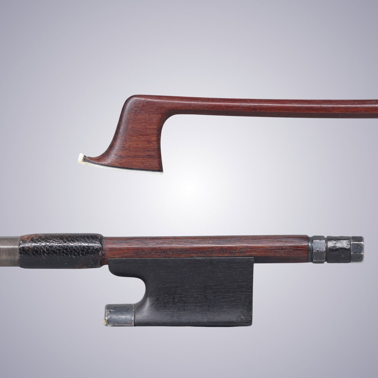 AN INTERESTING SILVER MOUNTED VIOLIN BOW STAMPED G.A. PFRETZSCHNER *** GERMANY: AN INTERESTING SILVER MOUNTED VIOLIN BOW STAMPED G.A. PFRETZSCHNER *** GERMANY Of Strong Octagonal Pernambuco Stick, Ebony & Silver mounted. Stamped on stick above frog: G.A. PFRETZSCHNER *** Stamped