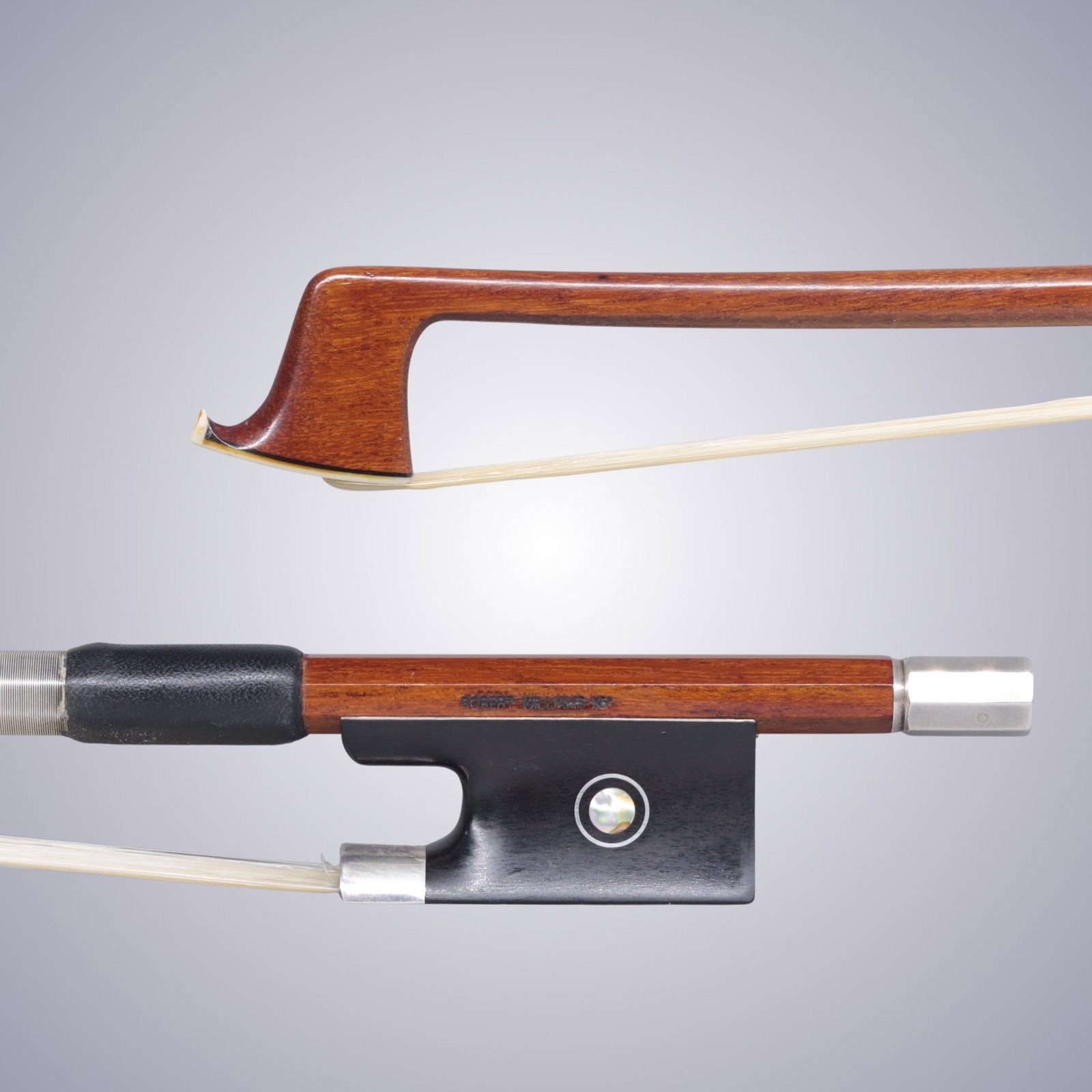 A SILVER MOUNTED VIOLIN BOW BY ROBERT WILLIAMS: A SILVER MOUNTED VIOLIN BOW BY ROBERT WILLIAMS Of Round Pernambuco Stick, Ebony & Silver mounted. Stamped on stick above frog: ROBERT WILLIAMS NY Approximate Dimensions: 74.5 cm (Total Length - Head