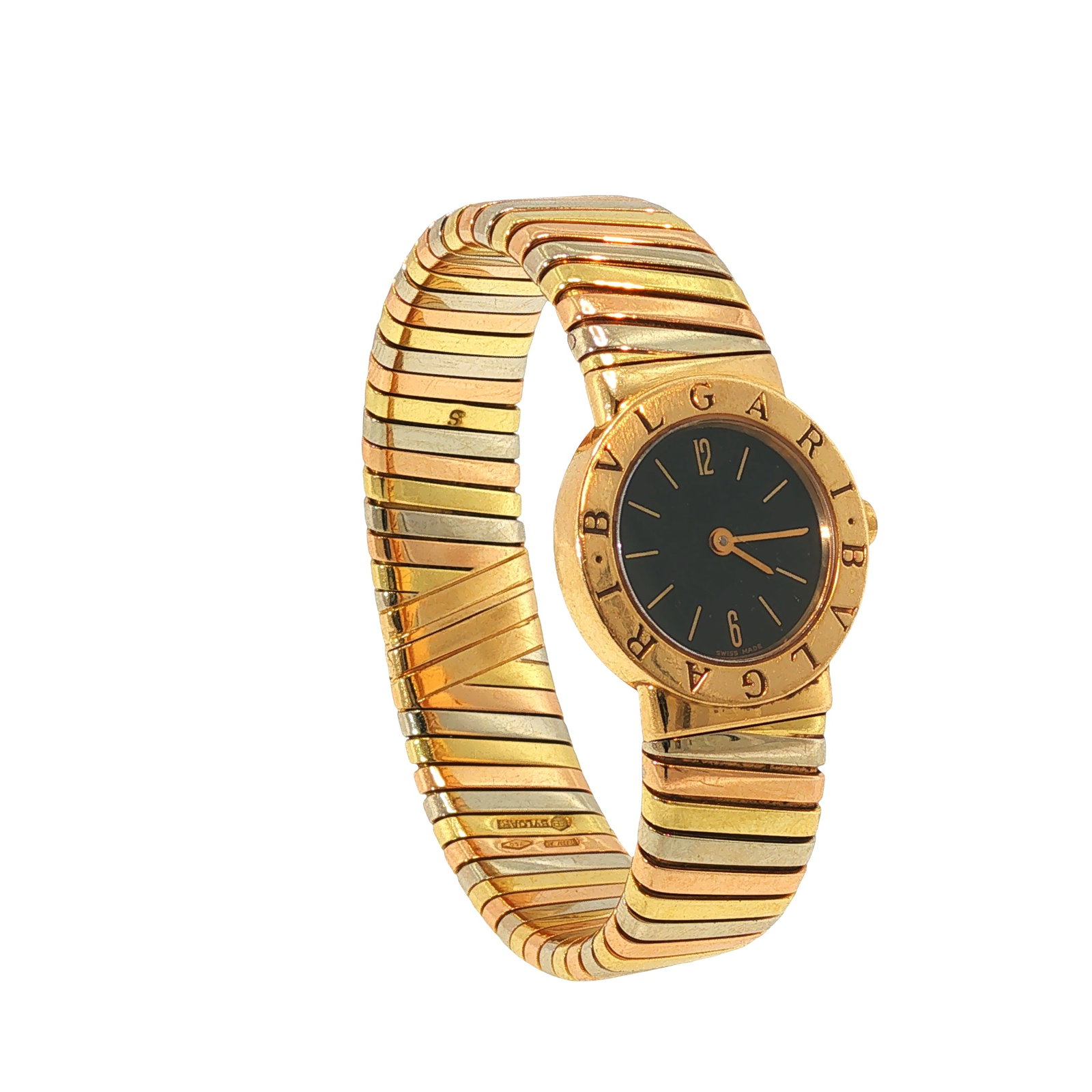 BULGARI 18K TRI-COLOR GOLD TUBOGAS WRISTWATCH: BULGARI 18K TRI-COLOR GOLD TUBOGAS WRISTWATCH Featuring a black dial within a signed circular case, integrated with Bulgari's iconic tri-color 18K gold Tubogas flexible bracelet. Swiss made. Approxima