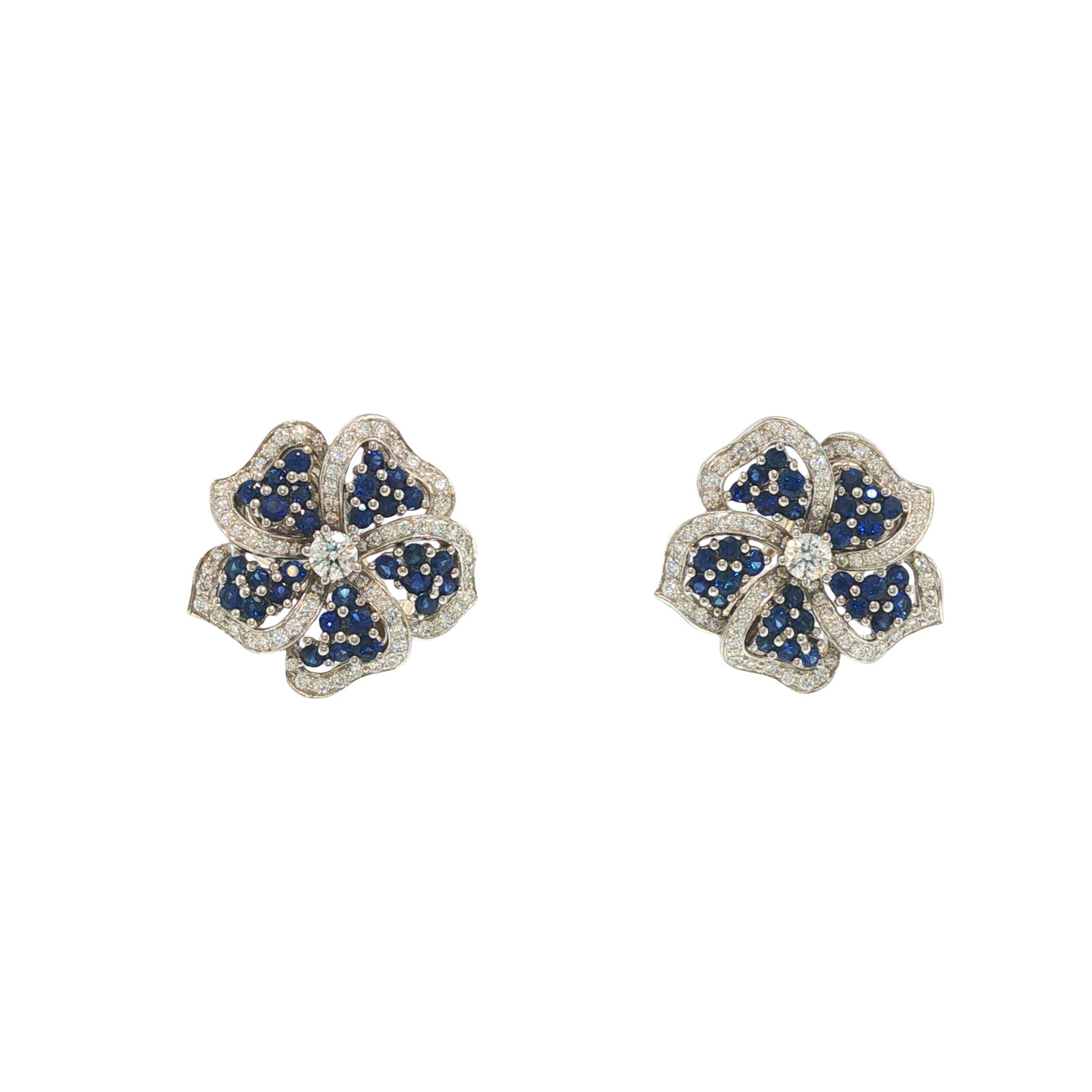 TIFFANY & CO. PLATINUM SAPPHIRE AND DIAMOND FLOWER EARRINGS: TIFFANY & CO. PLATINUM SAPPHIRE AND DIAMOND FLOWER EARRINGS Designed as a pair of stylized floral earrings, each centering a round brilliant-cut diamond within petals set with round sapphires and pave