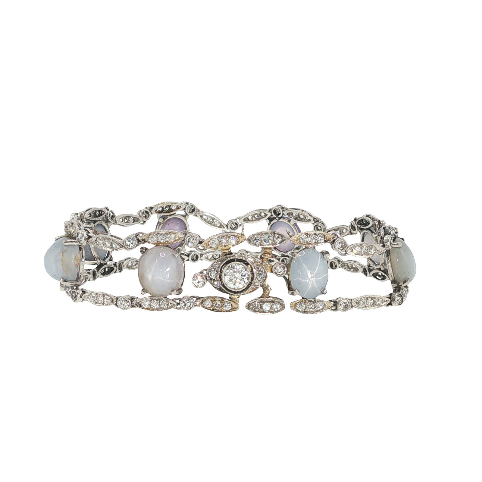 ART DECO TIFFANY & CO. PLATINUM DIAMOND AND STAR SAPPHIRE BRACELET: ART DECO TIFFANY & CO. PLATINUM DIAMOND AND STAR SAPPHIRE BRACELET An Art Deco Tiffany & Co. platinum bracelet set with star sapphires and diamonds, designed with articulated openwork links and oval d
