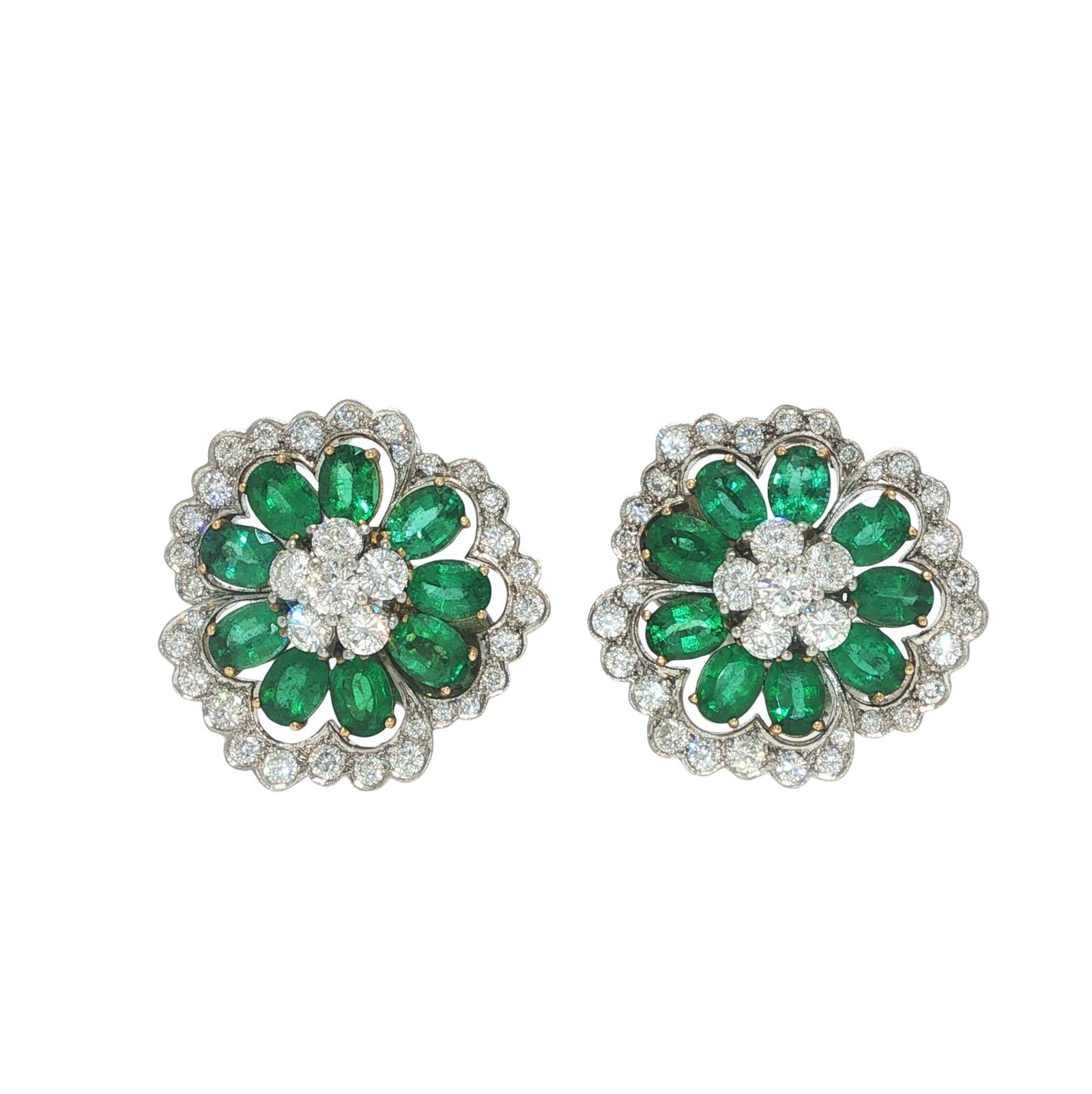 VAN CLEEF & ARPELS EMERALD AND DIAMOND CAMELLIA FLOWER EARRINGS: VAN CLEEF & ARPELS EMERALD AND DIAMOND CAMELLIA EARRINGS Designed as a pair of camellia earrings, each composed of pear-shaped emerald petals centering round brilliant-cut diamonds, within a surroundi