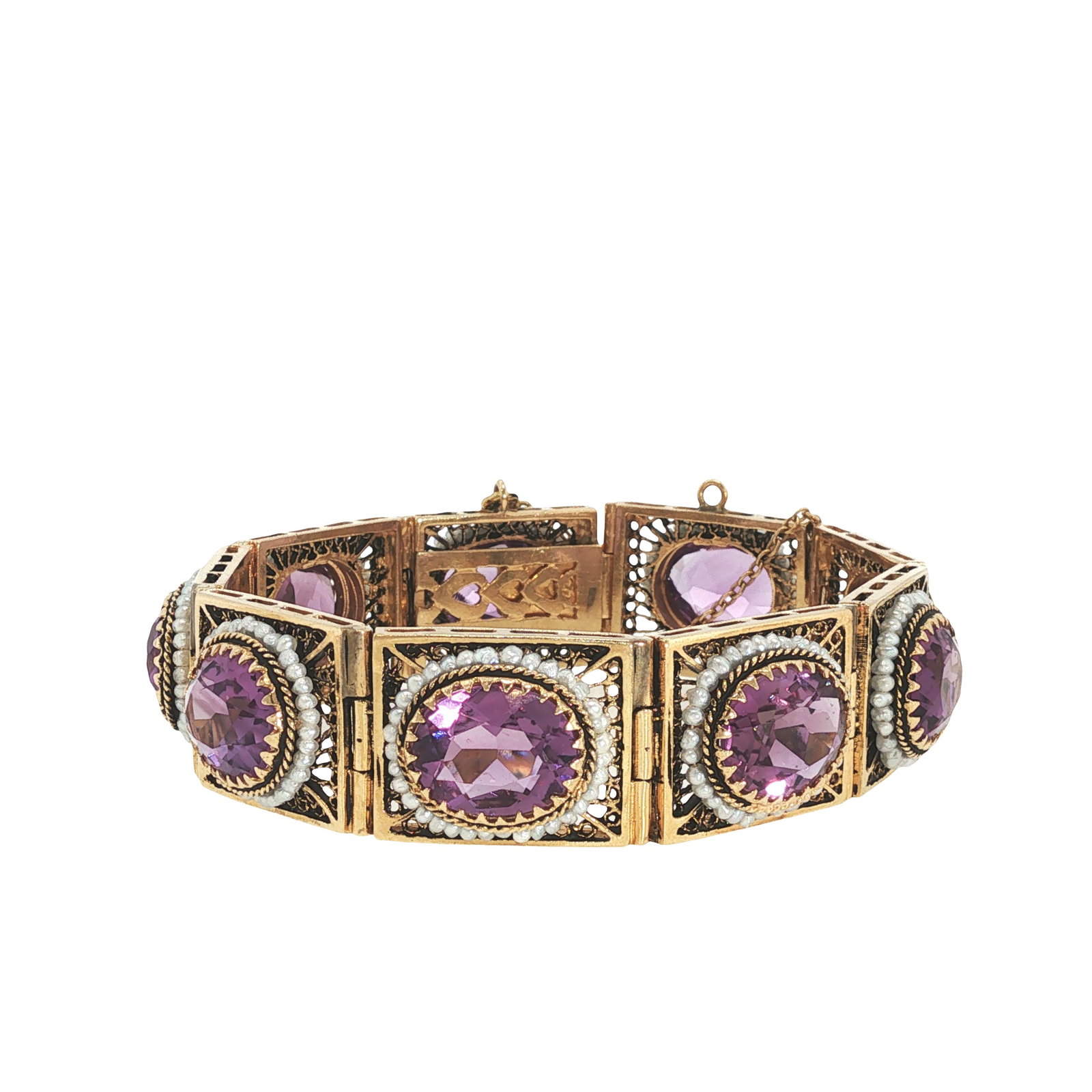 14K GOLD AMETHYST AND SEED PEARL BRACELET: 14K GOLD AMETHYST AND SEED PEARL BRACELET A hinged 14K gold panel bracelet set with six oval faceted amethysts, each framed by rope-twist borders and seed pearl surrounds. The rectangular openwork pan