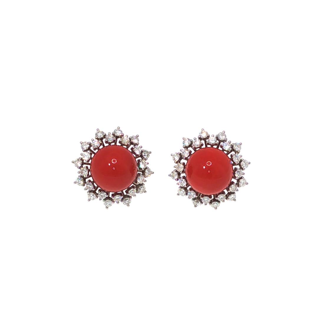 A PAIR OF PLATINUM RED CORAL & DIAMOND EARRINGS: A PAIR OF PLATINUM RED CORAL & DIAMOND EARRINGS Designed as a pair of platinum earrings, each centering a polished round red coral cabochon within a radiating halo of round brilliant-cut diamonds. The