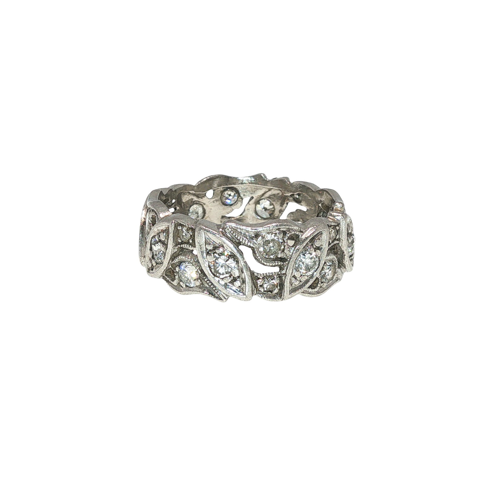 A DIAMOND RING: DIAMOND RING A diamond ring designed as an openwork band with repeating leaf-form and scroll motifs, set throughout with round diamonds. The pierced construction gives the ring a lace-like appearance,