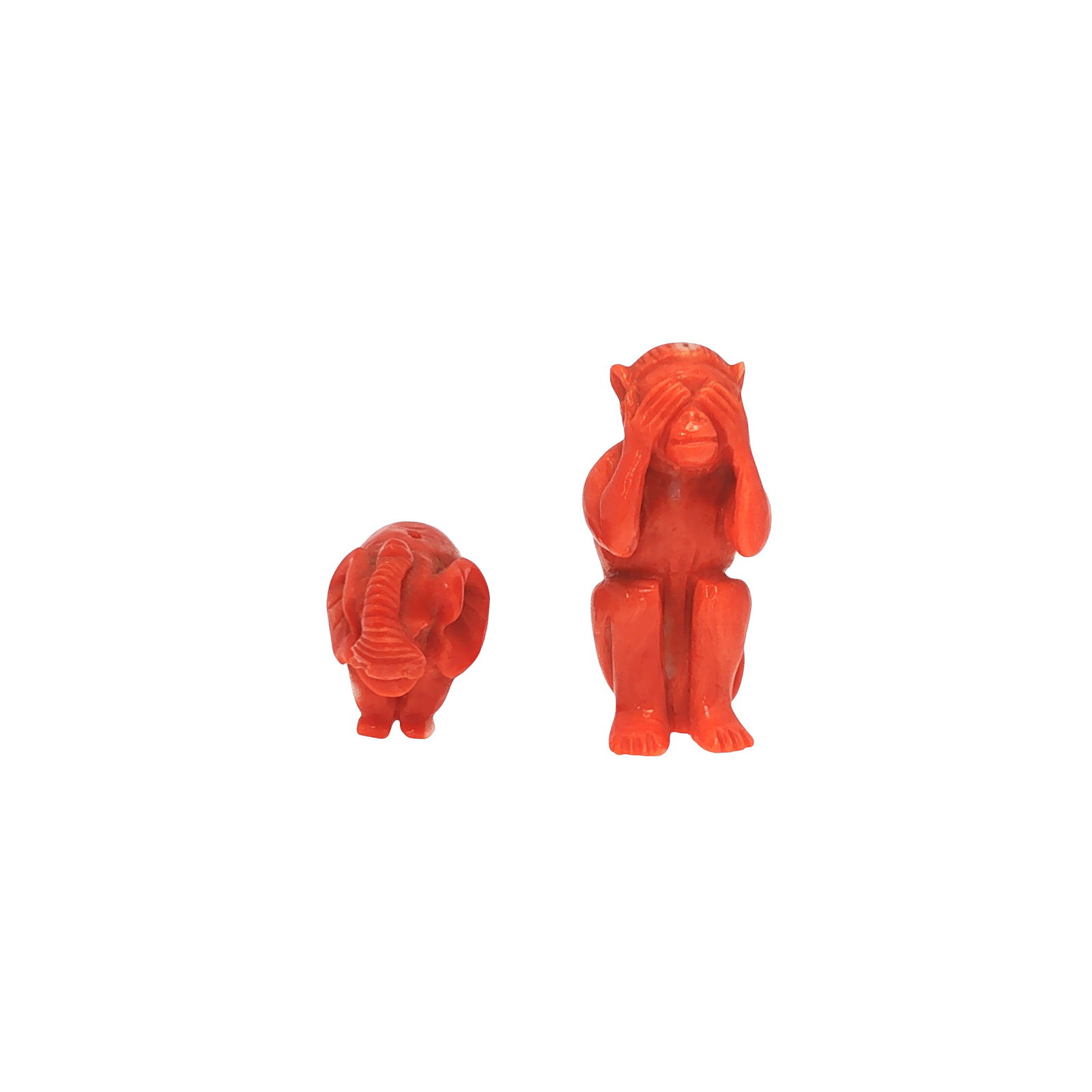 TWO CARVED NATURAL CORAL ANIMAL FIGURES, ELEPHANT AND MONKEY: TWO CARVED NATURAL CORAL ANIMAL FIGURES, ELEPHANT AND MONKEY Comprising two carved natural coral figures, modeled as an elephant and a monkey depicted in the traditional ""see no evil"" pose with its 