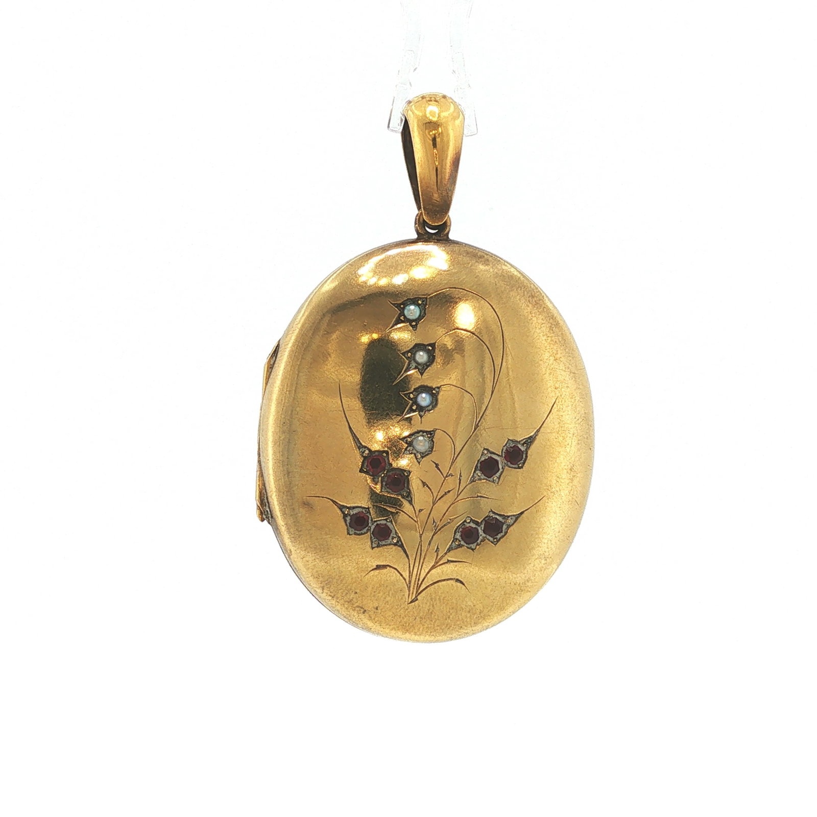 VICTORIAN 14K GOLD RUBY AND PEARL LOCKET PENDANT: VICTORIAN 14K GOLD RUBY AND PEARL LOCKET PENDANT A Victorian 14 karat yellow gold oval locket pendant, the front engraved with a graceful floral spray highlighted by seed pearls and round-cut rubies i