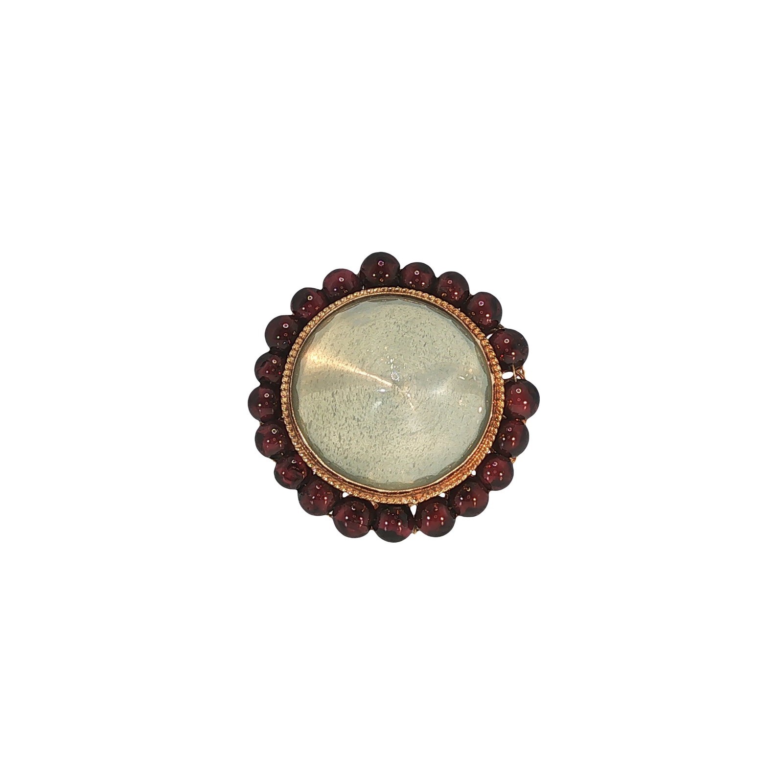 RETRO 14K GOLD MOONSTONE AND GARNET RING: RETRO 14K GOLD MOONSTONE AND GARNET RING A Retro-period 14K gold ring centered by a large circular moonstone cabochon displaying a soft adularescent sheen, framed by a border of round garnet cabochons