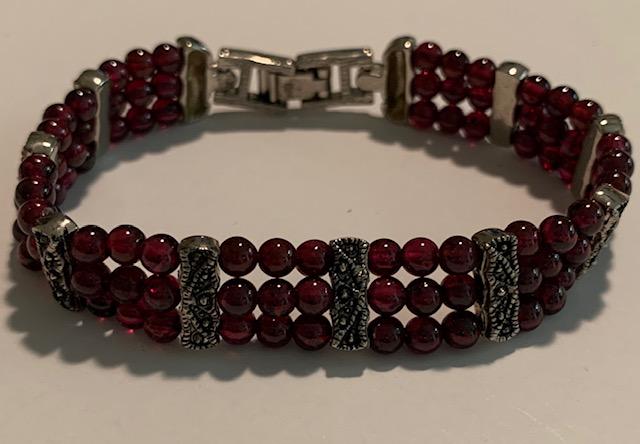 Bracelet 3 Strand Garnet Beads Bracelet 3 Strand with: Bracelet 3 Strand with Granet Beads 7" Silver Tone See Photo's for a Better Idea of Description and Condition.