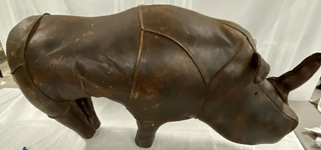 Vintage Leather Rhinoceros Footstool: Vintage Leather Rhinoceros Footstool Straw Filled. Missing eyes and one ear. Some seams have been reinforced. Aprox. 32" L x 9" W x 15" T.