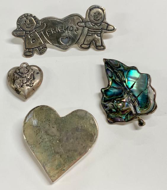 4 Piece Sterling Pin/Charm Lot: 4 Piece Sterling Pin/Charm Lot. *3 Sterling Brooches & Charm. Heart, Friends, Leaf w/ Abalone inlay, Heart Charm with Eagle. Photo's are considered part of the description and condition.