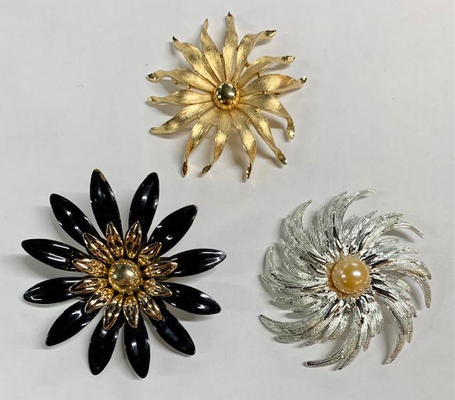 3 Designer Brooches - Sarah Cov. & Trifari: 3 Designer Brooches - Sarah Coventry and Trifari. *Sarah Coventry Silver Tone with Faux Pearl Flower Petal - Brooch. *Sarah Coventry Black Petal with Gold Tone Center - Brooch. *Trifari Gold Tone Flow