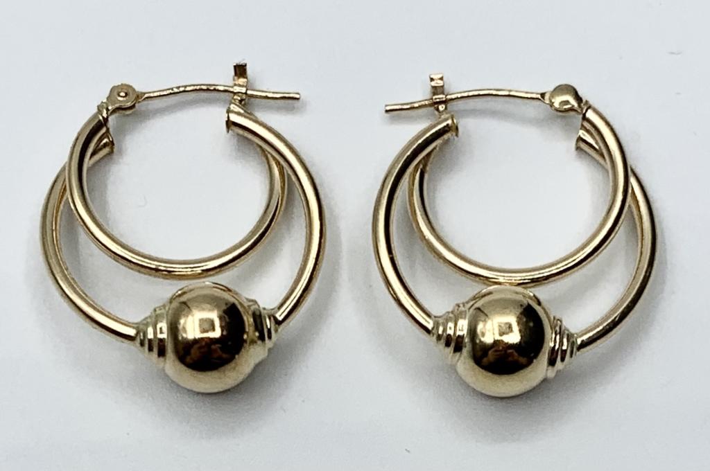 14k Double Hoop Earrings with Ball 1.8g: 14k Double Hoop Earrings with Ball. Pierced. 1.8g. Photo's are considered part of the description and condition.