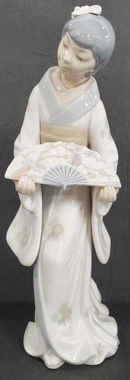 NAO Geisha Girl with Fan: NAO Geisha Girl with Fan. By Lladro . Apx. 10 1/2" H. No Box. Hand Made in Japan. Photos are considered part of the description and condition.