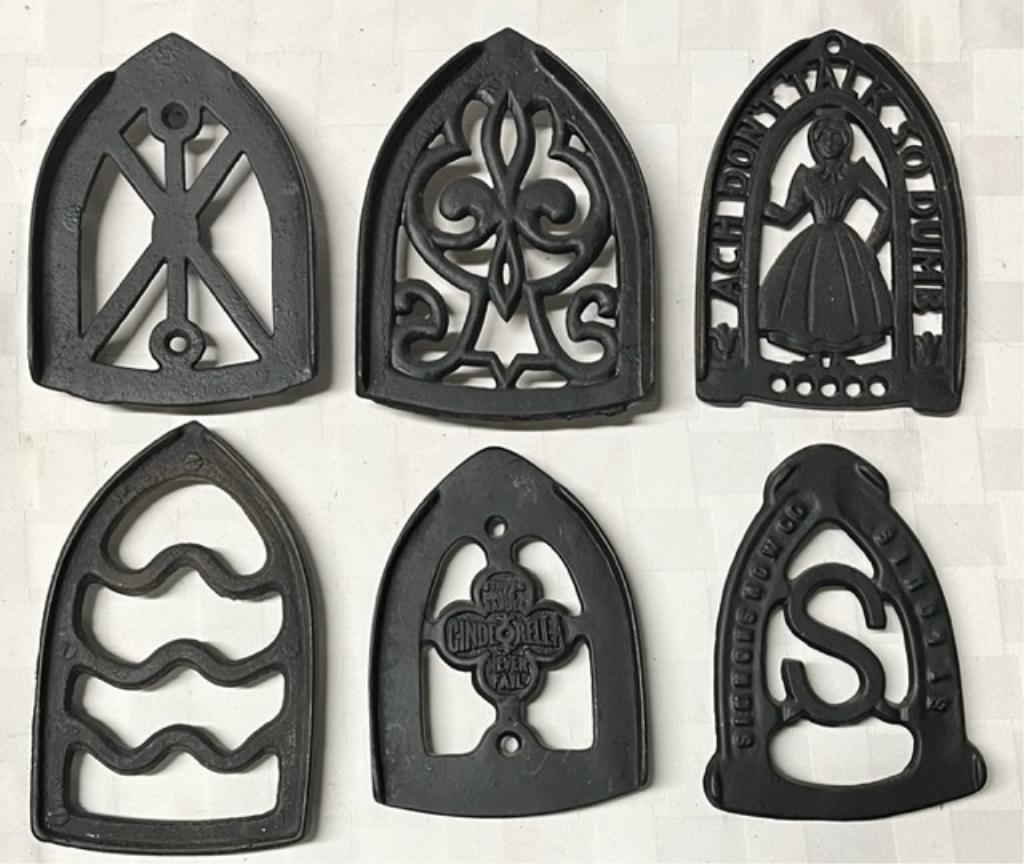 6 Vintage Cast Iron Footed Trivets: 6 Vintage cast iron footed trivets. Assorted sizes and designs. Photos are considered part of the description and condition.